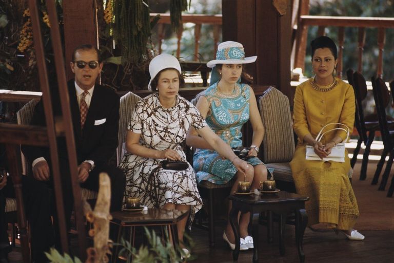 Queen Elizabeth II, Prince Philip Mountbatten, Duke of Edinburgh and Princess Anne pictured seated with Queen consort Sirikit of Thailand in Bangkok