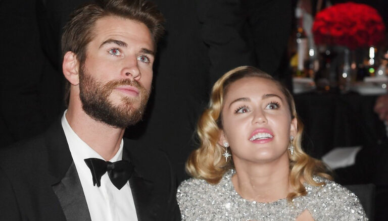 Liam Hemsworth (L) and Miley Cyrus