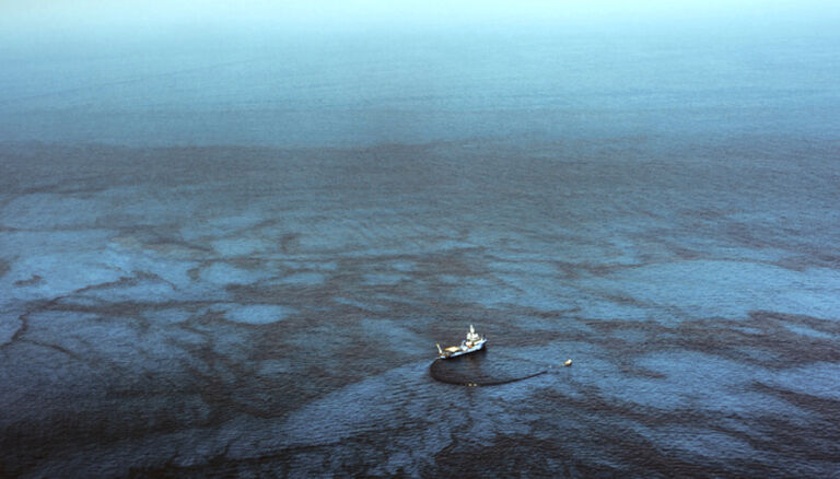 Industrial ship in oil spill on sea