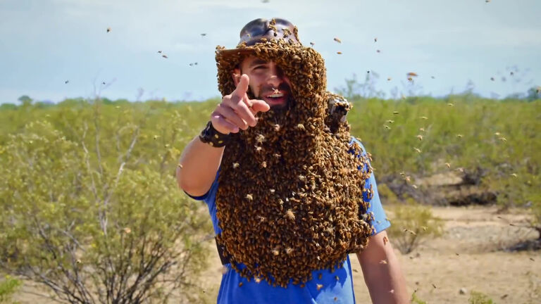 man covered with bees