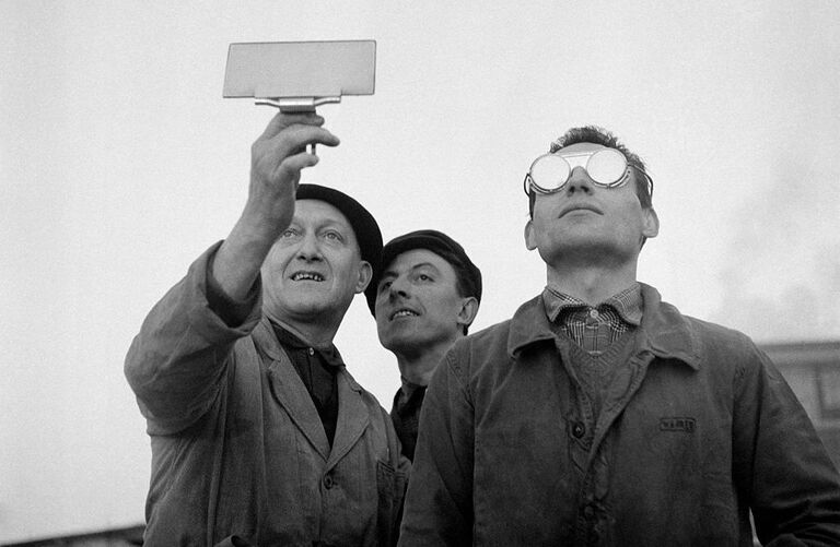 three men looking at the sky