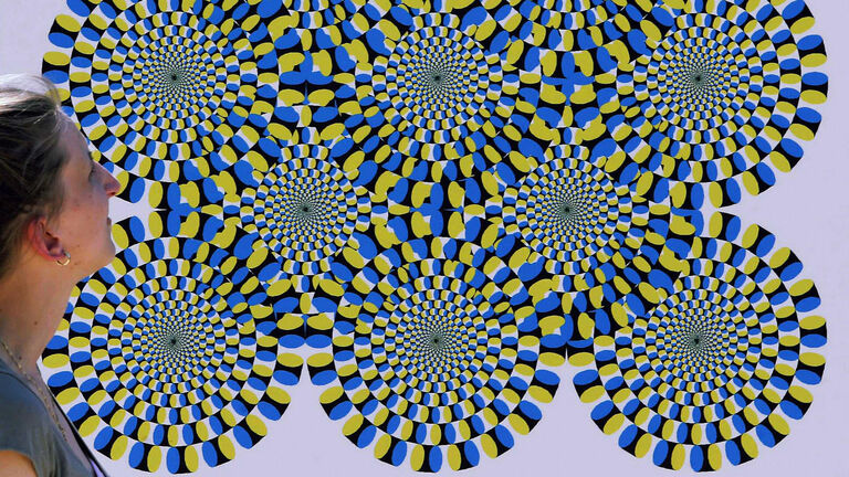woman watches an optical illusion