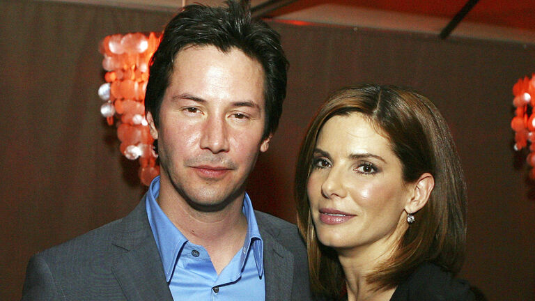 Actors Keanu Reeves (L) and Sandra Bullock pose at the afterparty for the premiere of Warner Bros