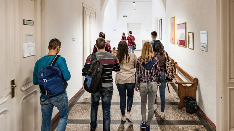 students walking school hallway