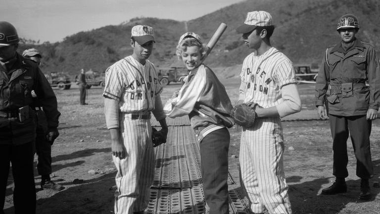 Marilyn Monroe poses with Ernest Abril and Manuel Abril