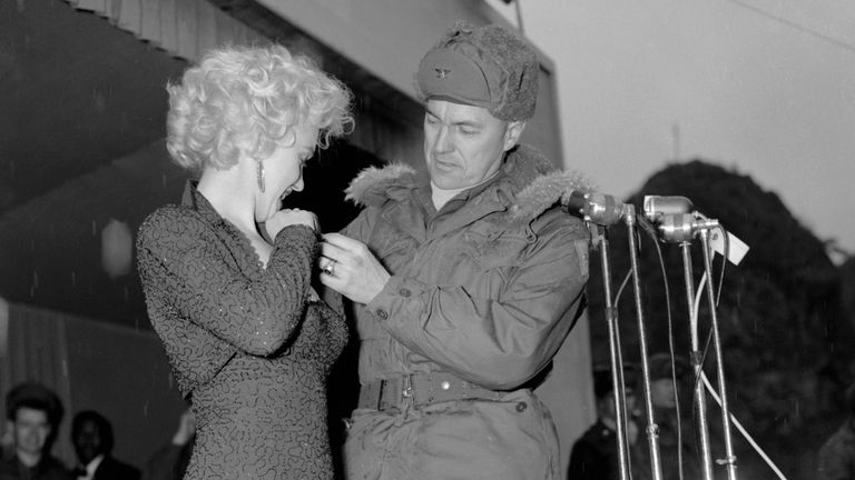 Marilyn Monroe Colonel John Kelly puts a 40th Division patch