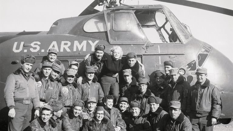 Marilyn Monroe with Army Airmen and a helicopter