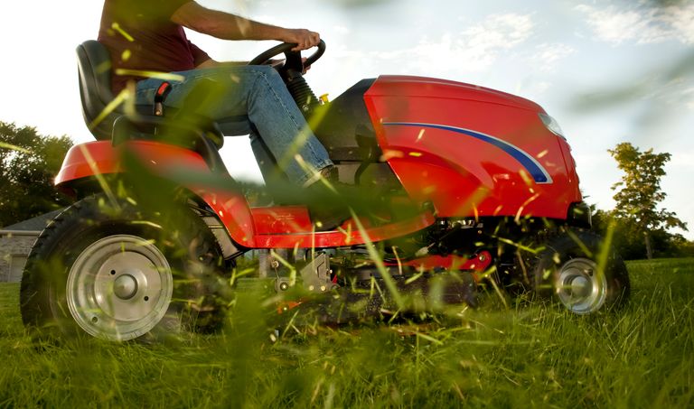 mower with flying grass clippings
