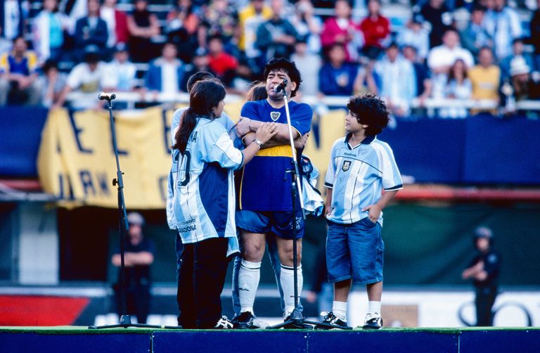 Diego Maradona with his children on a stage