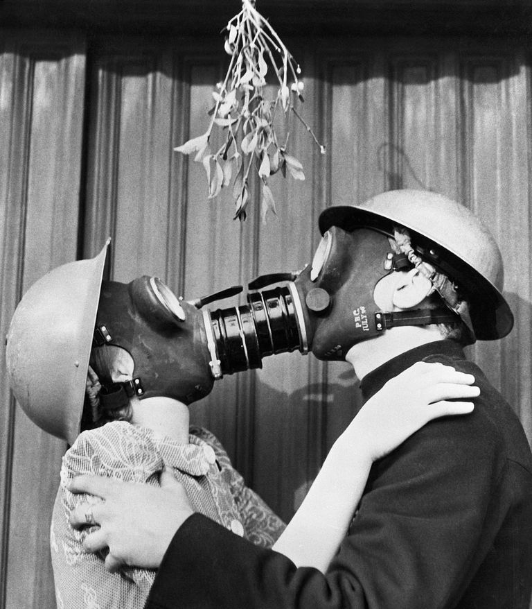 couple kissing through gas masks