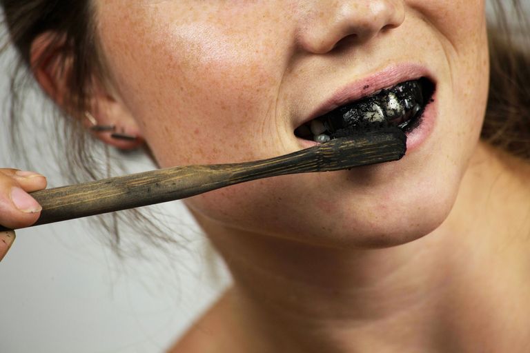 https://www.gettyimages.com/detail/photo/young-woman-brushing-her-teeth-with-a-black-tooth-royalty-free-image/1017236526?phrase=black%20teeth&adppopup=true