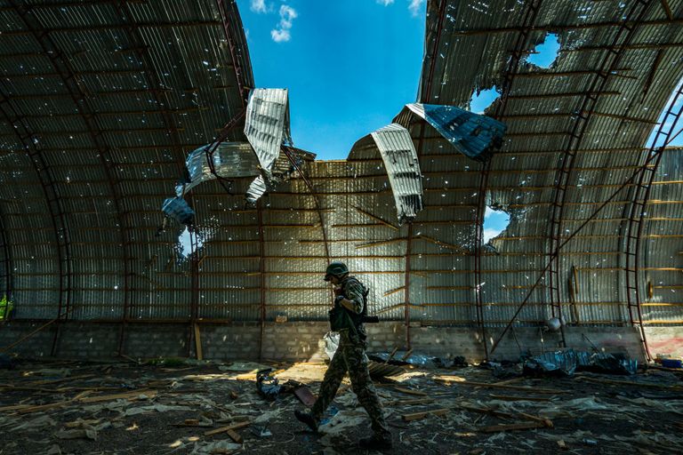 https://www.gettyimages.co.uk/detail/news-photo/ukrainian-soldier-walks-inside-a-destroyed-barn-by-russian-news-photo/1241276745?phrase=ukraine%20war&adppopup=true