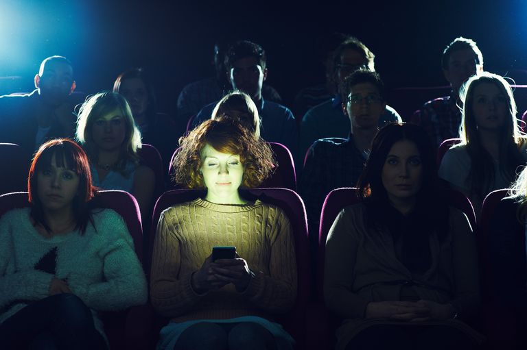 https://www.gettyimages.co.uk/detail/photo/woman-using-phone-during-movie-at-cinema-royalty-free-image/163296573 woman phone cinema