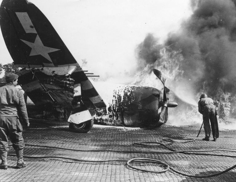 https://www.gettyimages.co.uk/detail/news-photo/an-american-soldier-turns-the-hose-on-a-burning-plane-after-news-photo/488640805 burning plane