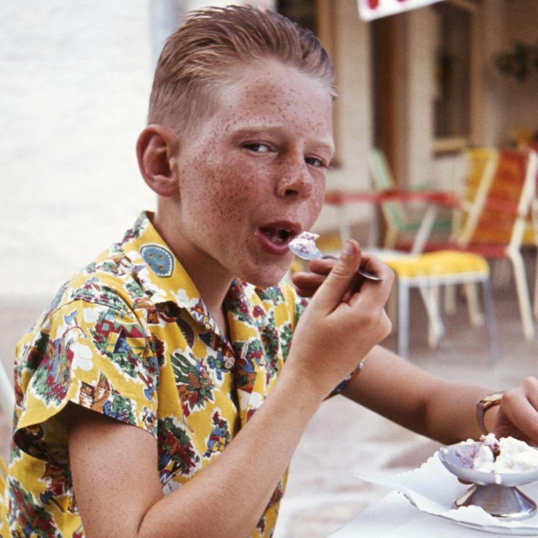 https://www.gettyimages.co.uk/detail/news-photo/germany-red-haired-boy-is-eating-ice-cream-in-a-pavement-news-photo/548156507?phrase=summer%20holiday&adppopup=true