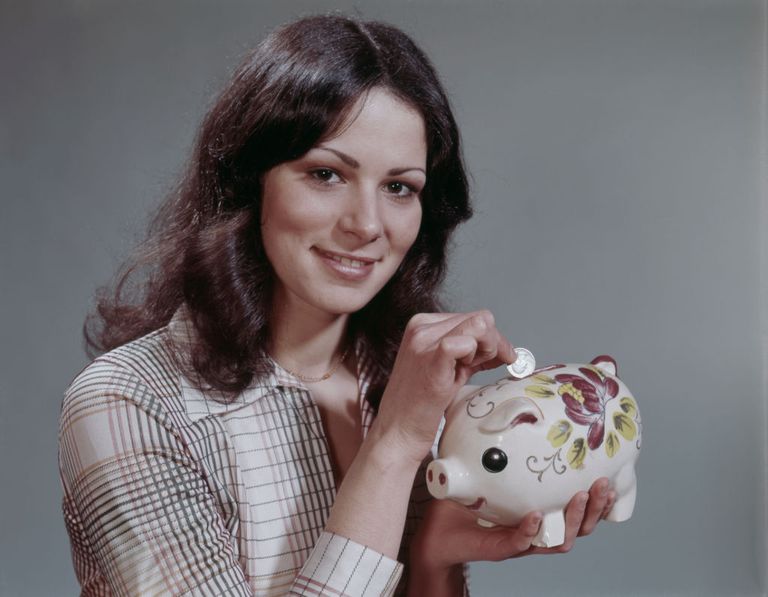 https://www.gettyimages.com/detail/news-photo/portrait-of-young-woman-filling-piggy-bank-news-photo/931862502?phrase=female%20save%20money%20color&adppopup=true