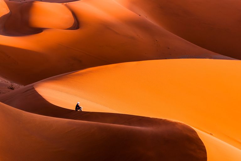https://www.gettyimages.co.uk/detail/photo/man-sitting-on-top-of-a-giant-dune-contemplating-royalty-free-image/1149822772