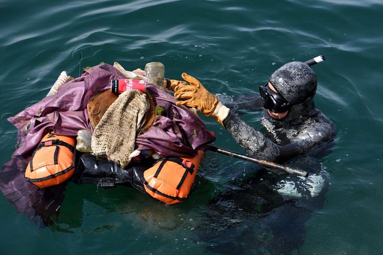 https://www.gettyimages.com/detail/news-photo/diver-is-seen-with-waste-during-collection-about-forty-news-photo/1241134827?adppopup=true