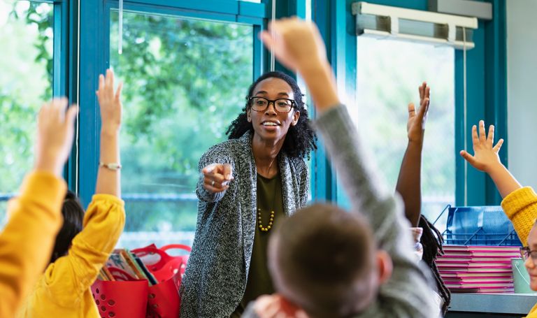 https://www.gettyimages.com/detail/photo/teacher-in-classroom-points-to-student-raising-hand-royalty-free-image/1457744422?phrase=teacher%20happy%20students&adppopup=true