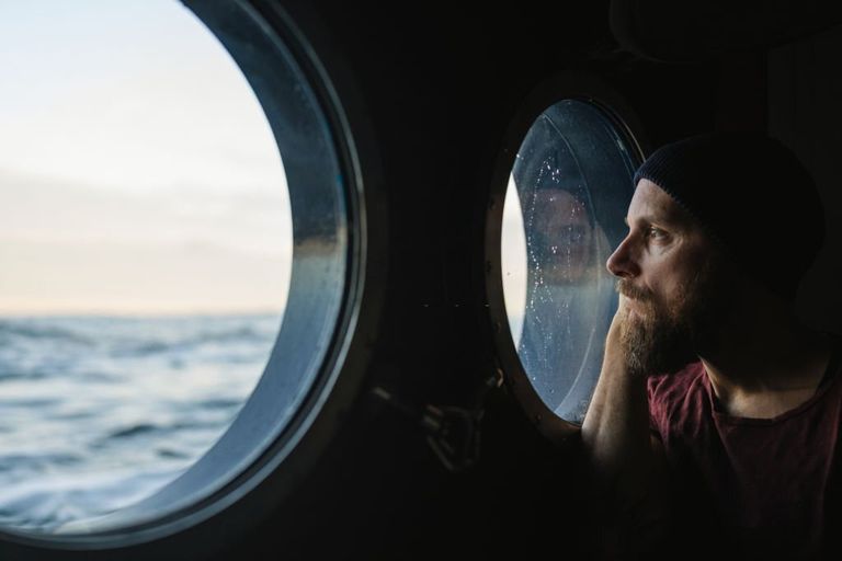 https://www.gettyimages.com/detail/photo/man-at-the-porthole-window-of-a-vessel-sailing-the-royalty-free-image/1356007841?phrase=cruise+ship&adppopup=true