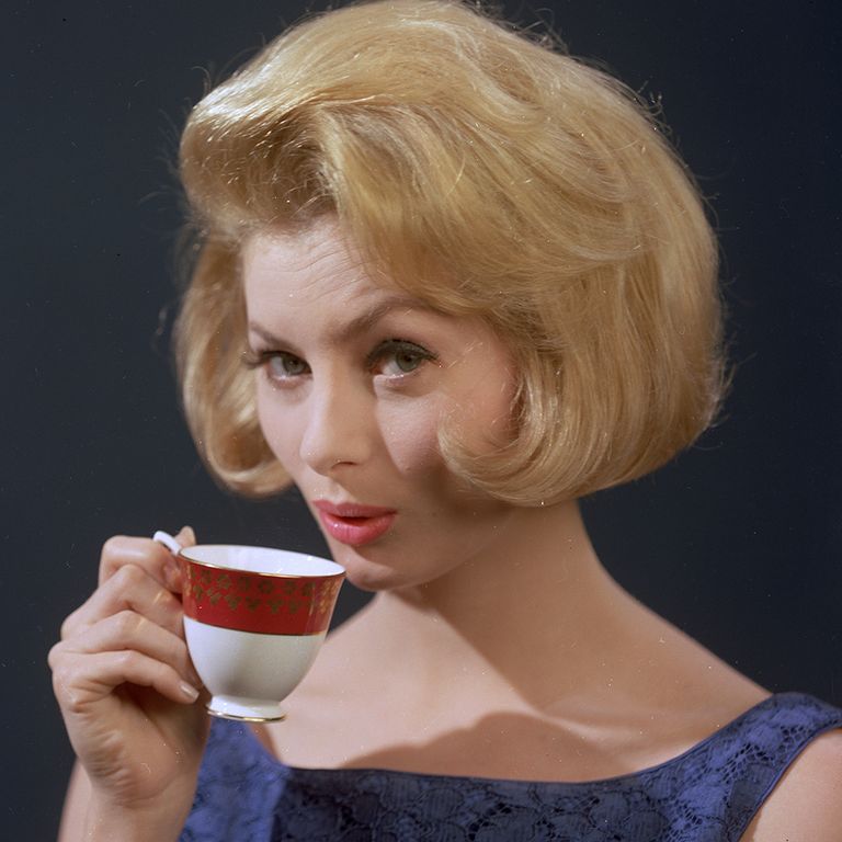 https://www.gettyimages.co.uk/detail/news-photo/well-groomed-young-woman-quenching-her-thirst-with-a-cup-of-news-photo/3163690