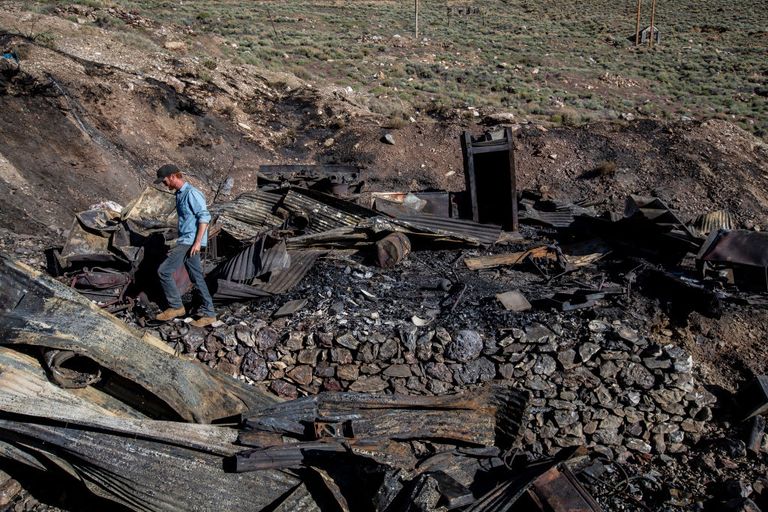 https://www.gettyimages.com/detail/news-photo/brent-underwood-hikes-amid-the-burned-tin-and-wooden-news-photo/1237554716?adppopup=true