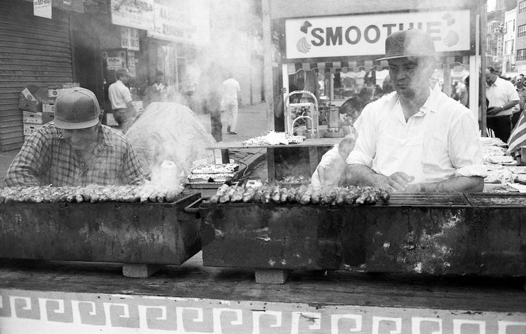 https://www.gettyimages.com/detail/news-photo/two-men-grills-kebabs-at-a-food-vendor-stall-on-9th-avenue-news-photo/1347762906