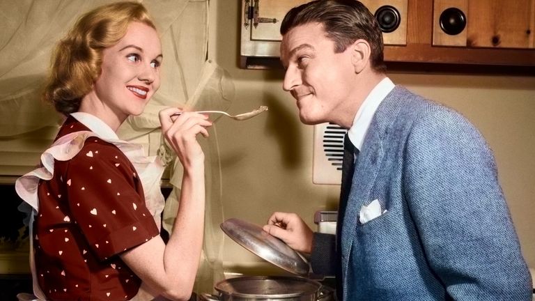 https://www.gettyimages.com/detail/news-photo/1950s-smiling-housewife-at-stove-giving-happy-husband-taste-news-photo/1382289021?adppopup=true
