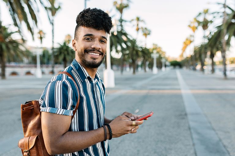 https://www.gettyimages.com/detail/photo/smiling-young-man-holding-smartphone-standing-royalty-free-image/1406050430?phrase=Spanish+people