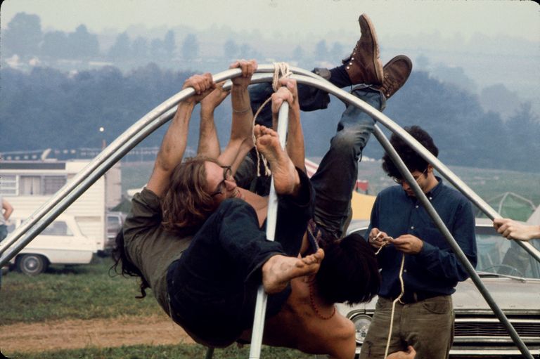 https://www.gettyimages.co.uk/detail/news-photo/three-festival-goers-hang-from-bent-metal-tubing-as-a-news-photo/96188765