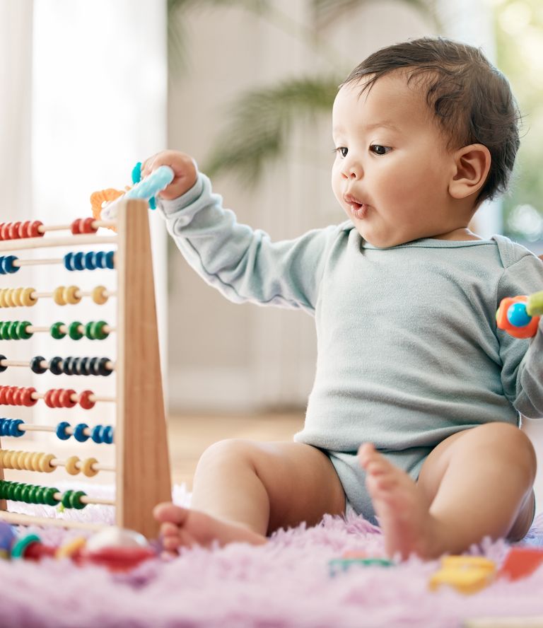 https://www.gettyimages.co.uk/detail/photo/shot-of-an-adorable-baby-playing-with-toys-at-home-royalty-free-image/1390160528