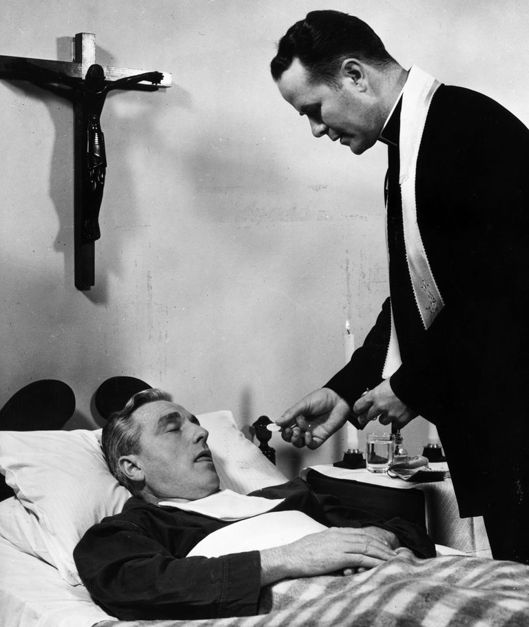 https://www.gettyimages.co.uk/detail/news-photo/catholic-priest-administers-the-host-to-a-dying-man-during-news-photo/3402477
