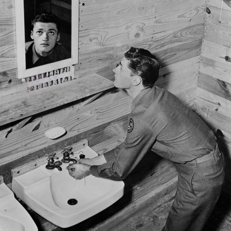 https://www.gettyimages.co.uk/detail/news-photo/soldier-looking-in-bathroom-mirror-with-a-reminder-to-news-photo/982761374