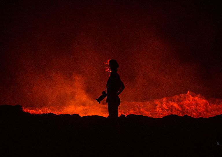 https://www.gettyimages.co.uk/detail/news-photo/tourist-in-front-of-the-living-lava-lake-in-the-crater-of-news-photo/587275572?adppopup=true