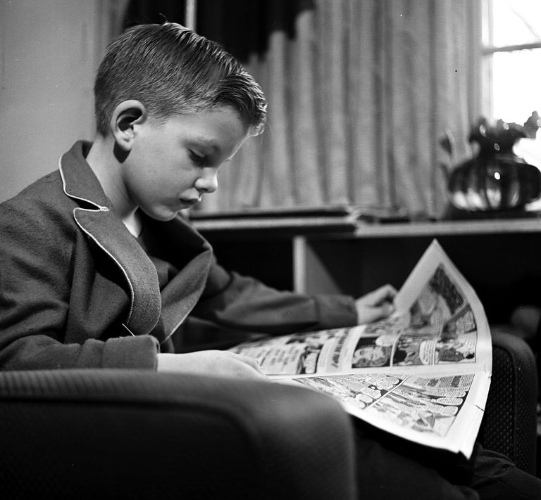 https://www.gettyimages.co.uk/detail/news-photo/young-boy-reads-the-comics-pages-of-a-newspaper-in-the-news-photo/492893505?adppopup=true