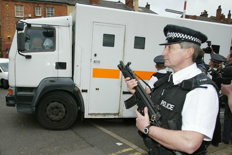 https://www.gettyimages.com/detail/news-photo/armed-police-stand-as-a-police-van-departs-from-leeds-crown-news-photo/828952556