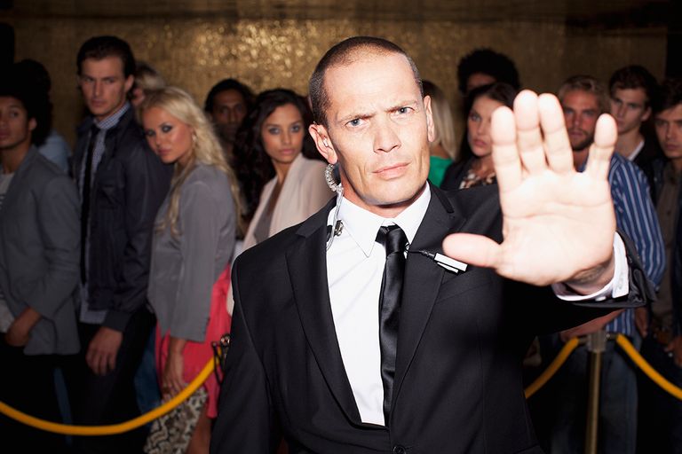 https://www.gettyimages.co.uk/detail/photo/portrait-of-bouncer-with-arm-outstretched-outside-royalty-free-image/160993257?phrase=nightclub+bouncer&adppopup=true