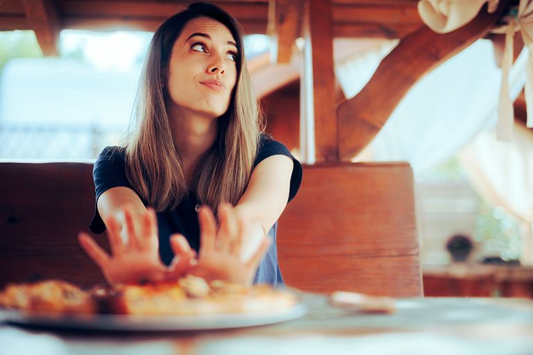 https://www.gettyimages.co.uk/detail/photo/unhappy-woman-refusing-to-eat-her-pizza-dish-in-a-royalty-free-image/1481096196?phrase=SKIPPING+MEAL&adppopup=true