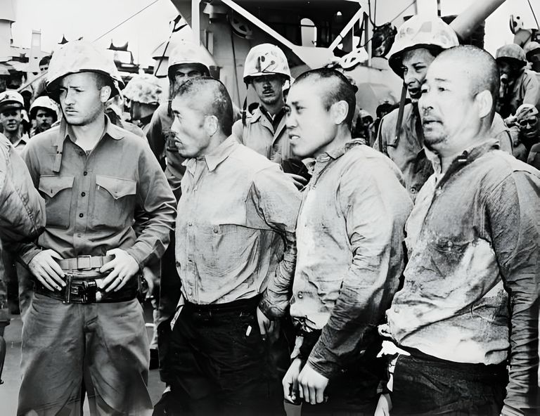 https://www.gettyimages.co.uk/detail/news-photo/three-japanese-prisoners-of-war-surrounded-by-american-news-photo/3139903
