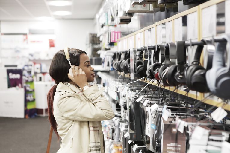 https://www.gettyimages.co.uk/detail/photo/young-woman-in-shop-looking-at-headphones-royalty-free-image/941744700