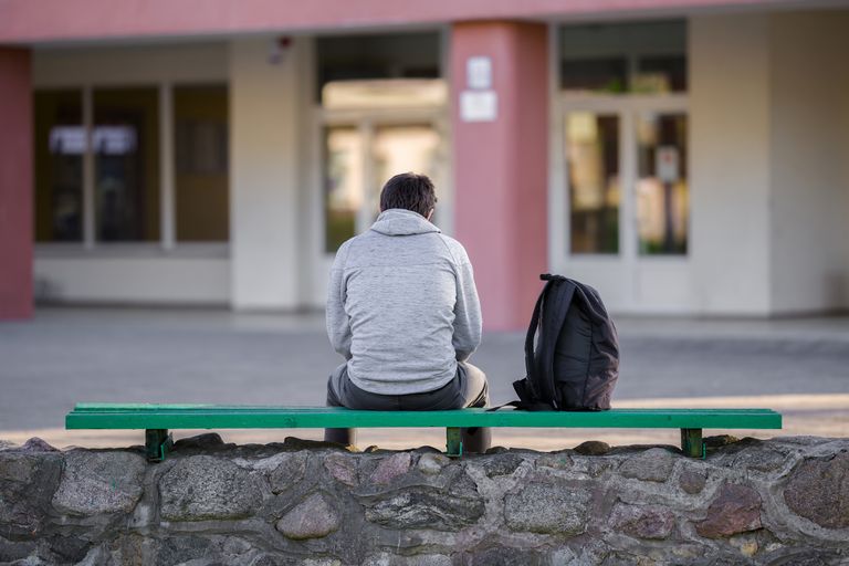 https://www.gettyimages.co.uk/detail/photo/one-young-man-sitting-on-bench-at-school-yard-break-royalty-free-image/1227303349