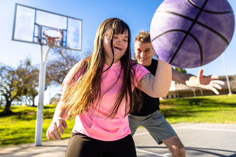 https://www.gettyimages.co.uk/detail/photo/girl-with-downs-syndrome-playing-basketball-with-royalty-free-image/1366683703