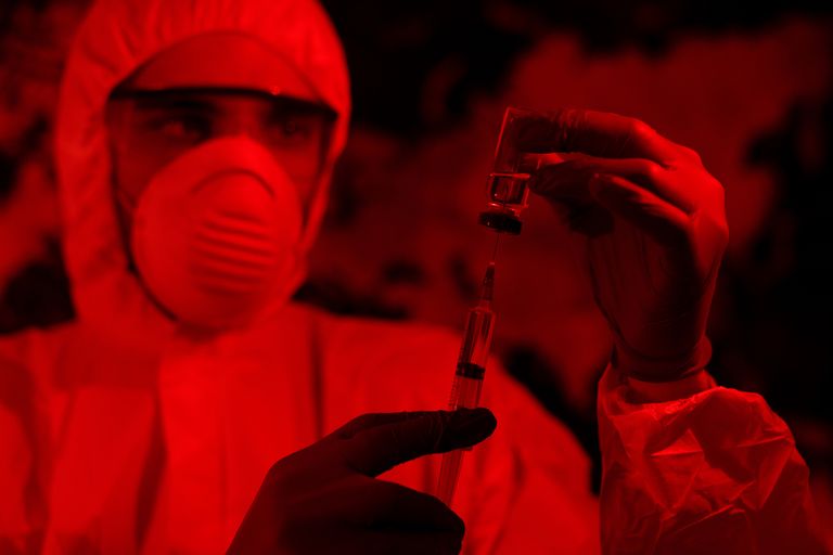 https://www.gettyimages.com/detail/photo/man-in-protective-suit-and-mask-holds-an-injection-royalty-free-image/1212566863?phrase=blood+harvesting++Conspiracy