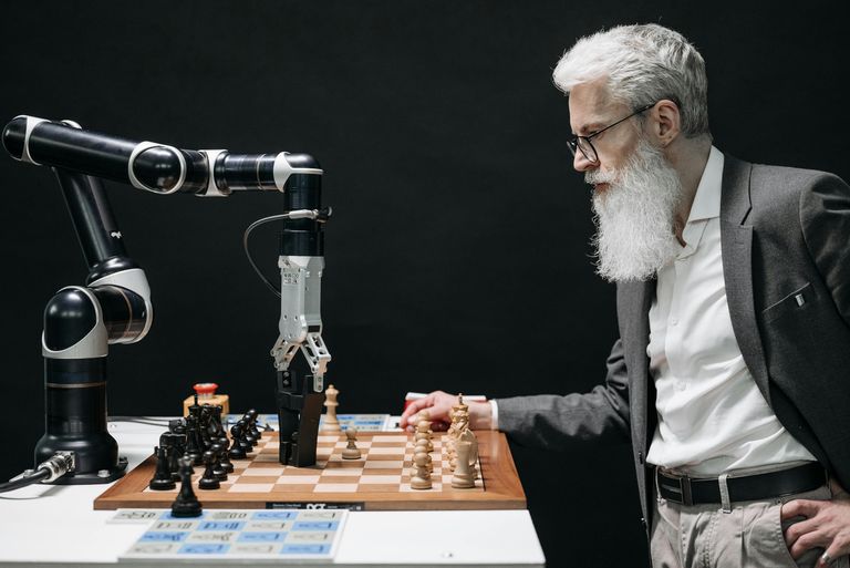 man robot playing chess