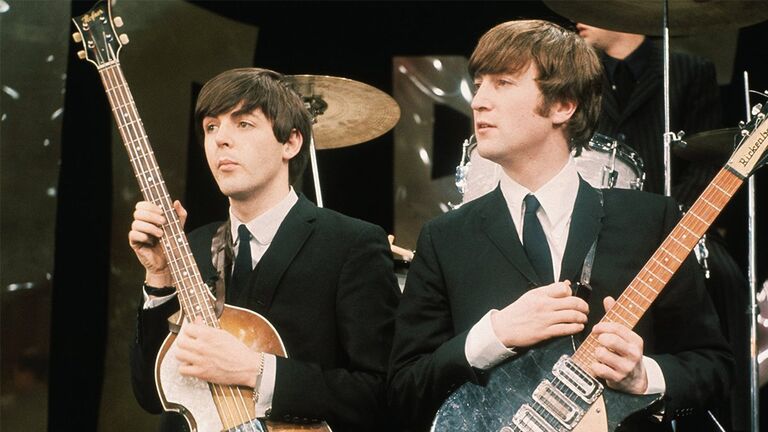 https://www.gettyimages.co.uk/detail/news-photo/paul-mccartney-and-john-lennon-hold-their-guitars-while-on-news-photo/515097396?adppopup=true